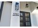 Modern house entrance with black door and light fixtures at 3782 Horace Ave, North Port, FL 34286