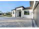Modern house exterior with paver driveway and landscaping at 3782 Horace Ave, North Port, FL 34286