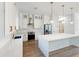 Bright kitchen featuring white cabinets, stainless steel appliances, and an island at 3782 Horace Ave, North Port, FL 34286