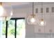 Glass globe pendant lights hang above kitchen island at 3782 Horace Ave, North Port, FL 34286