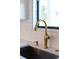 Close-up of elegant gold kitchen faucet and sink at 3782 Horace Ave, North Port, FL 34286