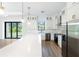 Modern kitchen with white cabinets, stainless steel appliances, and island at 3782 Horace Ave, North Port, FL 34286