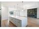 Open concept kitchen and living area with a modern fireplace and island at 3782 Horace Ave, North Port, FL 34286