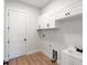 Bright laundry room with white cabinets and sink at 3782 Horace Ave, North Port, FL 34286