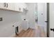 Laundry room with white cabinets, sink, and access to kitchen at 3782 Horace Ave, North Port, FL 34286