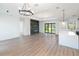 Open living room with fireplace and sliding glass doors at 3782 Horace Ave, North Port, FL 34286