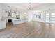 Open concept living room and kitchen with hardwood floors at 3782 Horace Ave, North Port, FL 34286