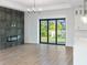 Living room with fireplace, sliding doors, and high ceilings at 3782 Horace Ave, North Port, FL 34286