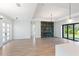 Open living area with hardwood floors, fireplace, and sliding glass doors at 3782 Horace Ave, North Port, FL 34286
