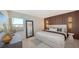 Serene bedroom with a king-size bed and wood accent wall at 420 Beach Rd # 407, Sarasota, FL 34242