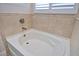 Relaxing bathroom with a soaking tub and tile surround at 4326 Silo Port Ct, Lakewood Ranch, FL 34211