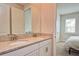 Double vanity bathroom with granite countertops and updated fixtures at 4326 Silo Port Ct, Lakewood Ranch, FL 34211