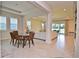Open dining room with glass table and chairs, view to living room at 4326 Silo Port Ct, Lakewood Ranch, FL 34211