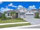 Two-story home with gray siding, stone accents, and a three-car garage at 4326 Silo Port Ct, Lakewood Ranch, FL 34211