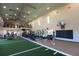 Indoor fitness center with turf area, weight equipment, and basketball hoop at 4326 Silo Port Ct, Lakewood Ranch, FL 34211
