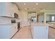 Modern kitchen with white cabinets, granite countertops, and island with seating at 4326 Silo Port Ct, Lakewood Ranch, FL 34211