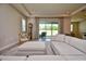 Living room with sectional sofa, ottoman, and large window with backyard view at 4326 Silo Port Ct, Lakewood Ranch, FL 34211