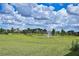 Community pond with fountain, grass, and trees at 4326 Silo Port Ct, Lakewood Ranch, FL 34211