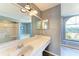 Bathroom boasts a vanity, large mirror, and shower/tub combo at 4581 E Dover Street Cir, Bradenton, FL 34203