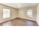 Well-lit bedroom with wood-look flooring and ceiling fan at 4581 E Dover Street Cir, Bradenton, FL 34203