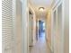 Long hallway with tile flooring and access to bedrooms and closets at 4581 E Dover Street Cir, Bradenton, FL 34203