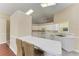 Bright kitchen features white cabinetry, ample counter space, and breakfast bar at 4581 E Dover Street Cir, Bradenton, FL 34203