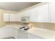 White kitchen with ample cabinetry and electric range at 4581 E Dover Street Cir, Bradenton, FL 34203