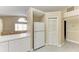 Kitchen area with white cabinets and refrigerator at 4581 E Dover Street Cir, Bradenton, FL 34203