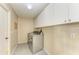 Laundry room with washer, dryer, and cabinets at 4581 E Dover Street Cir, Bradenton, FL 34203