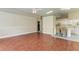 Living room with view into kitchen and wood floors at 4581 E Dover Street Cir, Bradenton, FL 34203