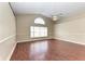 Living room with wood floors and arched window at 4581 E Dover Street Cir, Bradenton, FL 34203