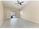 Living room with vaulted ceiling, tile flooring, and sliding doors to pool at 4581 E Dover Street Cir, Bradenton, FL 34203