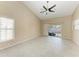 Living room with vaulted ceiling, tile flooring, and sliding doors to pool at 4581 E Dover Street Cir, Bradenton, FL 34203