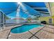 Relaxing kidney-shaped pool with covered patio at 4581 E Dover Street Cir, Bradenton, FL 34203