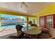 Covered patio with pool view and wicker furniture at 4581 E Dover Street Cir, Bradenton, FL 34203