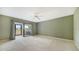 Bright bedroom with patio access and ceiling fan at 4781 Chandlers Forde # 5, Sarasota, FL 34235