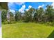 Spacious backyard offering a tranquil, wooded setting at 4892 Hillman Ter, North Port, FL 34288
