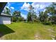 Large backyard with lush green grass and trees at 4892 Hillman Ter, North Port, FL 34288