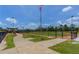 Baseball field with a pathway and seating area at 4892 Hillman Ter, North Port, FL 34288