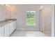 Clean bathroom, double vanity, shower, and a window at 4892 Hillman Ter, North Port, FL 34288