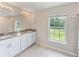 Bathroom with granite countertop double vanity and large window at 4892 Hillman Ter, North Port, FL 34288