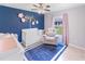 Bright Bedroom with crib, armchair, and plenty of natural light at 4892 Hillman Ter, North Port, FL 34288