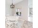Bright dining area with white table and chairs, near kitchen at 4892 Hillman Ter, North Port, FL 34288