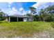 Single-story home with backyard and screened patio at 4892 Hillman Ter, North Port, FL 34288