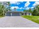 Beautiful house exterior with three car garage and landscaping at 4892 Hillman Ter, North Port, FL 34288