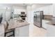 Open kitchen boasting granite countertops and stainless steel appliances at 4892 Hillman Ter, North Port, FL 34288