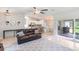 Open living room with leather sofa and kitchen view at 4892 Hillman Ter, North Port, FL 34288