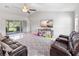 Living room with sliding doors leading to backyard patio at 4892 Hillman Ter, North Port, FL 34288