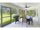 Spacious screened patio with outdoor dining set and grill at 4892 Hillman Ter, North Port, FL 34288