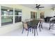 Covered patio with outdoor dining area and ceiling fan at 4892 Hillman Ter, North Port, FL 34288